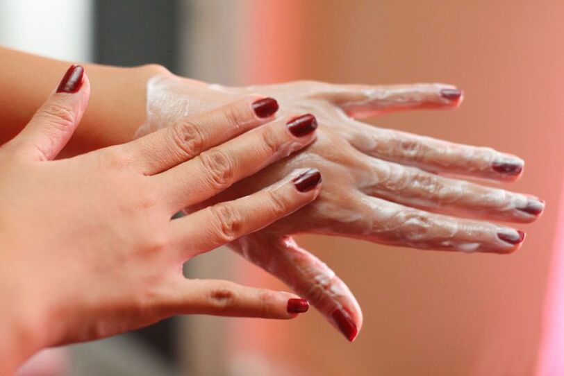 applying hand cream to rejuvenate the skin